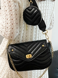 Quilted black crossbody bag with gold hardware and removable round coin purse