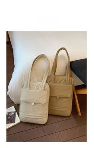 Detail of quilted tote bag with front flap pocket in cream and khaki colors
