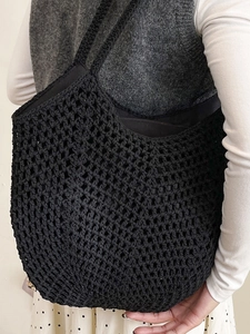Minimalist black crochet tote bag with openwork knit design for beach and casual vacations