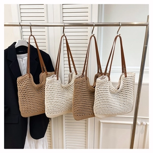 Detailed close-up of woven straw tote bags with leather handles in beige and brown