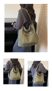 Detail of green corduroy tote bag showing metal magnetic buckle and wide shoulder strap