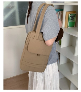 Lifestyle view of a beige canvas tote bag with magnetic flap pocket and large capacity