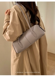Minimalist lavender leather tote bag worn with a beige coat in a retro aesthetic