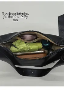 Spacious interior of black leather crossbody bag showing large capacity for daily items
