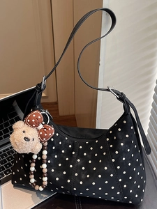 Polka dot shoulder bag in black suede with plush bear charm and beaded strap detail