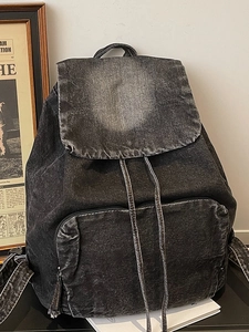 Retro washed black denim backpack with large capacity drawstring closure and front pocket