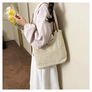 Detail of hand-woven crochet tote with mesh pattern and premium brown leather handle