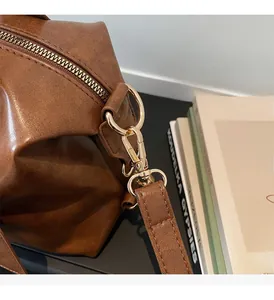Detail of premium golden hardware and brown leather texture on stylish handbag