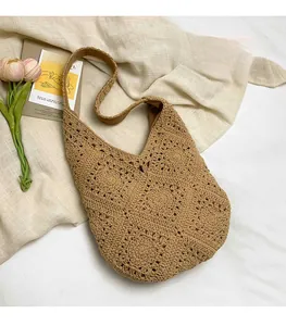 Macro shot of handcrafted crochet flower patterns on a brown woven tote bag surface