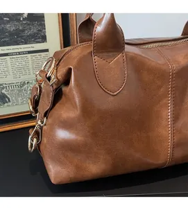 Close-up of brown vintage Boston bag showing detailed leather texture and stitching