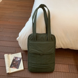Detailed view of the olive green quilted tote bag with multi-compartment functional pockets