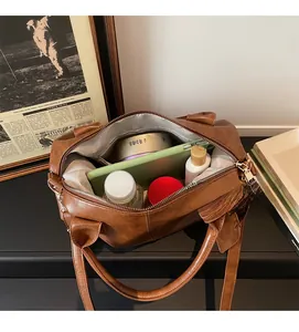 Detail view of large brown leather tote bag interior with multiple storage compartments