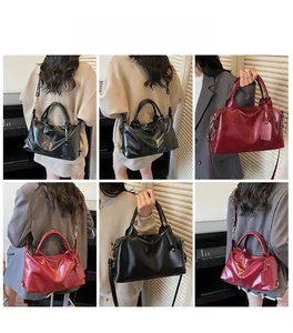 Detail view of retro Boston handbag in red and black showing various carrying styles