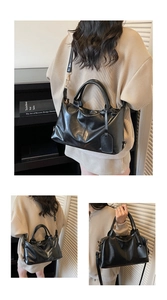 Macro view of large black tote bag showing smooth PU leather texture and adjustable strap