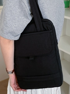 Large black commuter tote bag with multi-compartments shown on a shoulder