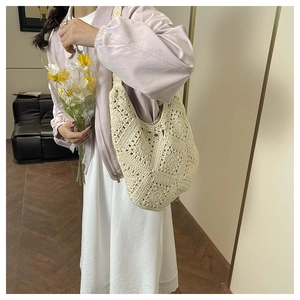Detail of cream woven crochet tote bag showing handmade floral patterns and soft cotton texture