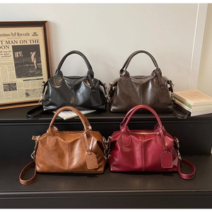 Detail of vintage Boston handbags in black, dark brown, caramel, and burgundy glossy leather