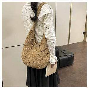 Detailed close-up of brown woven hobo bag showing handmade crochet texture and large capacity