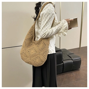 Detail of bohemian woven tote bag showing brown crochet texture and large shoulder strap