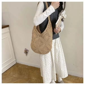 Close-up of khaki crochet hobo bag showing intricate floral knit texture and large capacity