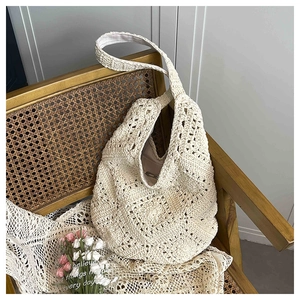 Close-up of cream woven tote bag showing detailed crochet pattern and fabric lining