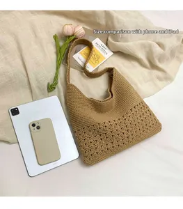 Detail shot of brown knit tote bag with iPad and phone for size comparison
