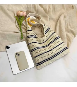 Detailed view of striped woven tote bag showing large capacity for iPad and phone