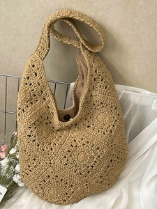 Khaki woven tote bag with floral crochet patterns and a magnetic metal clasp