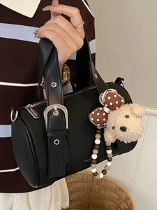 Retro black leather bowling bag with plush bear charm and adjustable shoulder strap