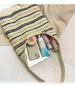 Detail view of woven striped tote bag interior showing large capacity for tablet and cosmetics