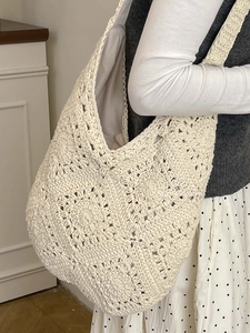 White woven tote bag featuring floral crochet knit texture and a large capacity shoulder design