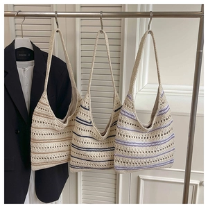 Detail of three woven hollow knit tote bags in white, navy blue, and purple stripe colors