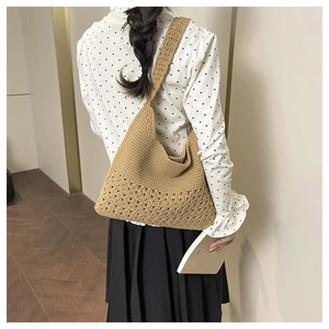 Detail view of woven crochet tote bag showing natural straw texture and hollow pattern
