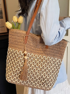 Large woven straw tote bag with color blocking design and elegant leather straps