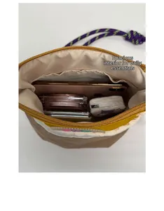 Detail view showing spacious interior capacity of the color-block crossbody bag