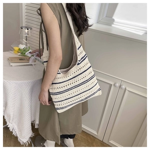 Detailed close-up of the hollow woven mesh texture and blue stripes on the tote bag