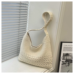 Detail of bohemian cream woven tote bag showing intricate crochet patterns and wide strap