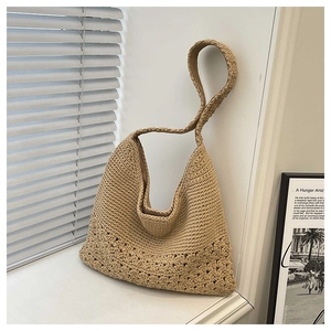 Detail of hollow crochet texture and beige handwoven fabric on large tote bag