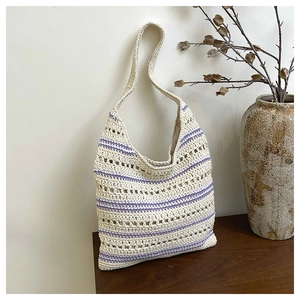 Detailed macro view of handcrafted crochet texture with purple stripes on a tote bag