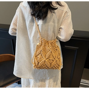 Detailed macro view of woven straw bucket bag showing diamond geometric crochet pattern