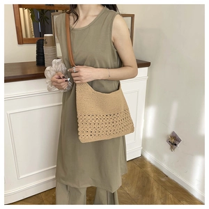 Detail of hand-woven beige shoulder bag featuring exquisite hollow patterns and leather strap