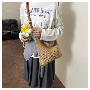 Detail of hand-woven shoulder bag with hollow pattern and adjustable leather strap
