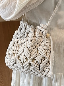 Chic woven macrame straw bucket bag in cream white with wooden bead drawstring details