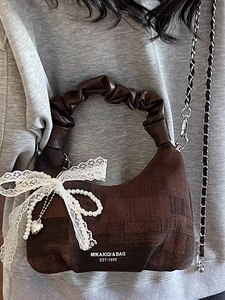 Dark brown crescent dumpling bag with lace bow, pearl charm, and silver chain strap