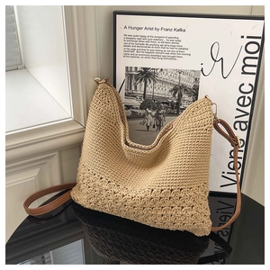 Detailed close-up of beige woven beach bag showing intricate hollow crochet patterns