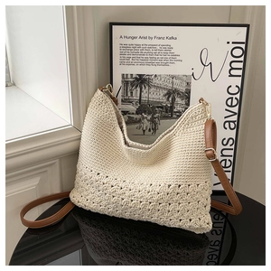 Detail of bohemian cream woven crochet shoulder bag with intricate cutout patterns