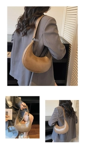 Detail showing vintage brown crescent shoulder bag with textured finish and adjustable strap