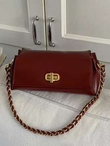 Classic dark red leather square shoulder bag with gold metal buckle and woven chain strap