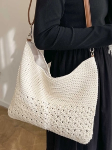 Chic woven beach bag in cream white with brown leather strap and floral hollow base