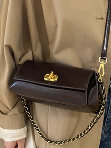 Classic dark brown leather shoulder bag with gold twist lock and woven chain strap